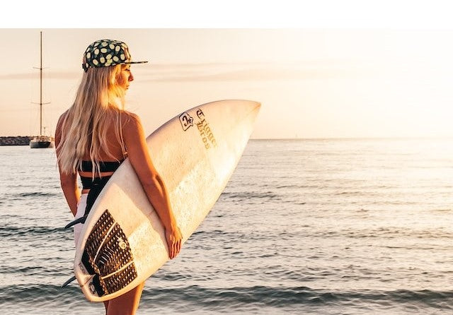 https://www.cheapsurfgear.com/cdn/shop/articles/girl-with-traction-pad_1600x.jpg?v=1659771406